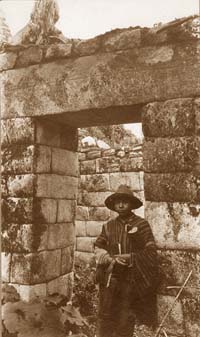 A young Peruvian boy in an doorway at Machu Picchu.